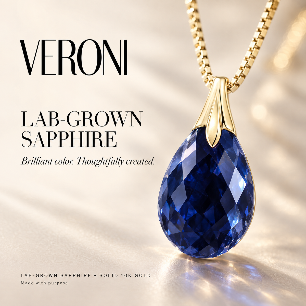 Yellow Gold Amabile lab-grown sapphire pendant on a warm ivory background in a VERONI campaign.
