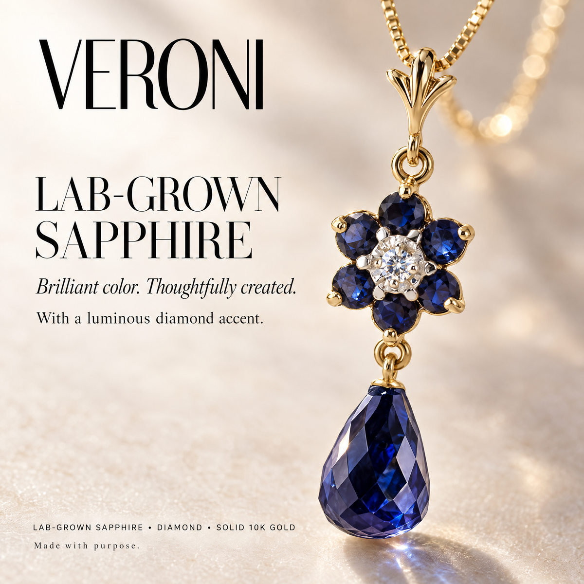 Yellow Gold Cassandra lab-grown sapphire and diamond pendant on a warm ivory background in a VERONI campaign.