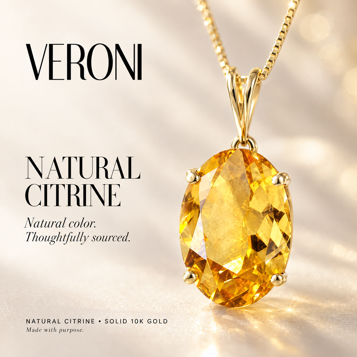 Yellow Gold Gemma natural citrine pendant on a warm ivory background in a VERONI campaign.