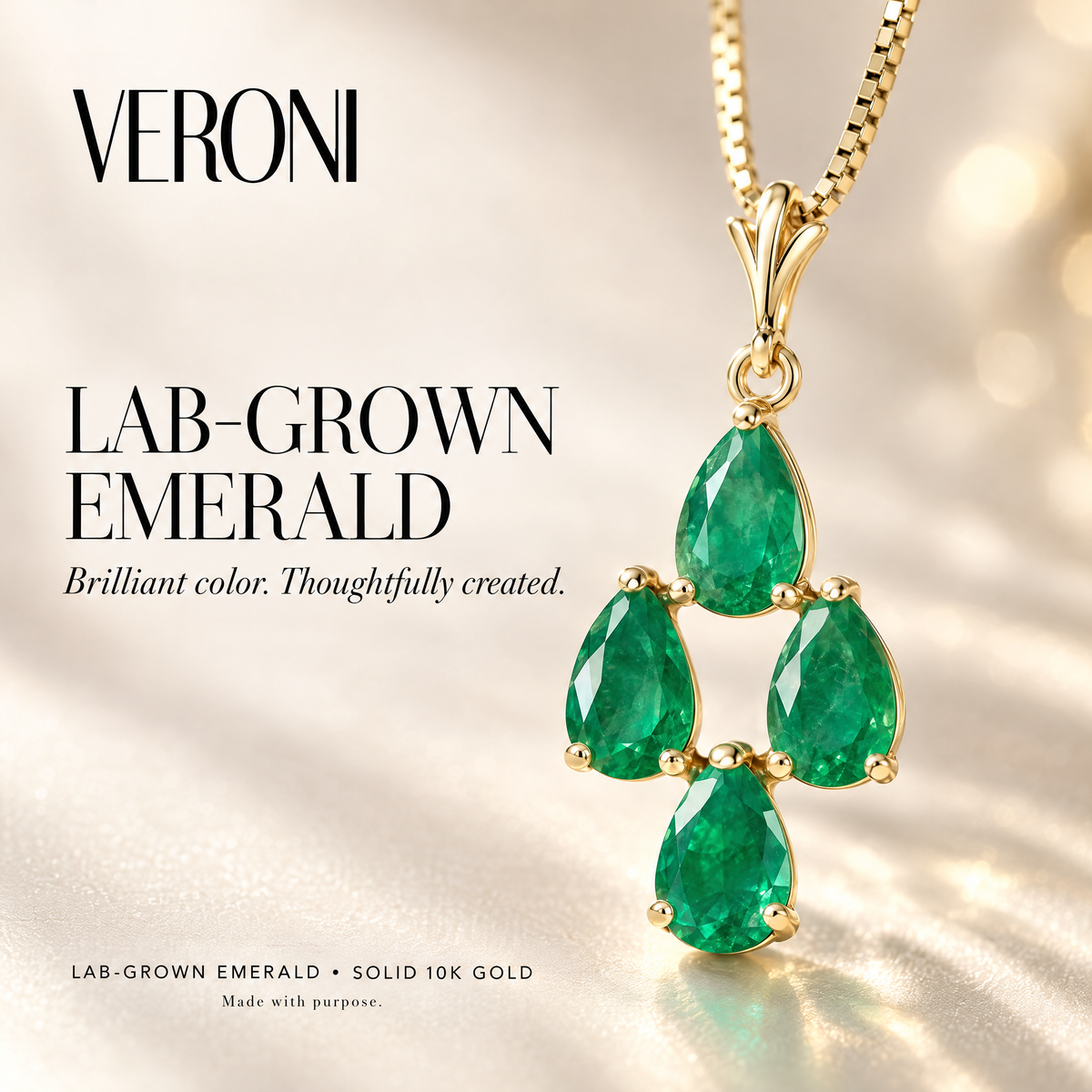 Yellow Gold Marta lab-grown emerald pendant on a warm ivory background in a VERONI campaign.