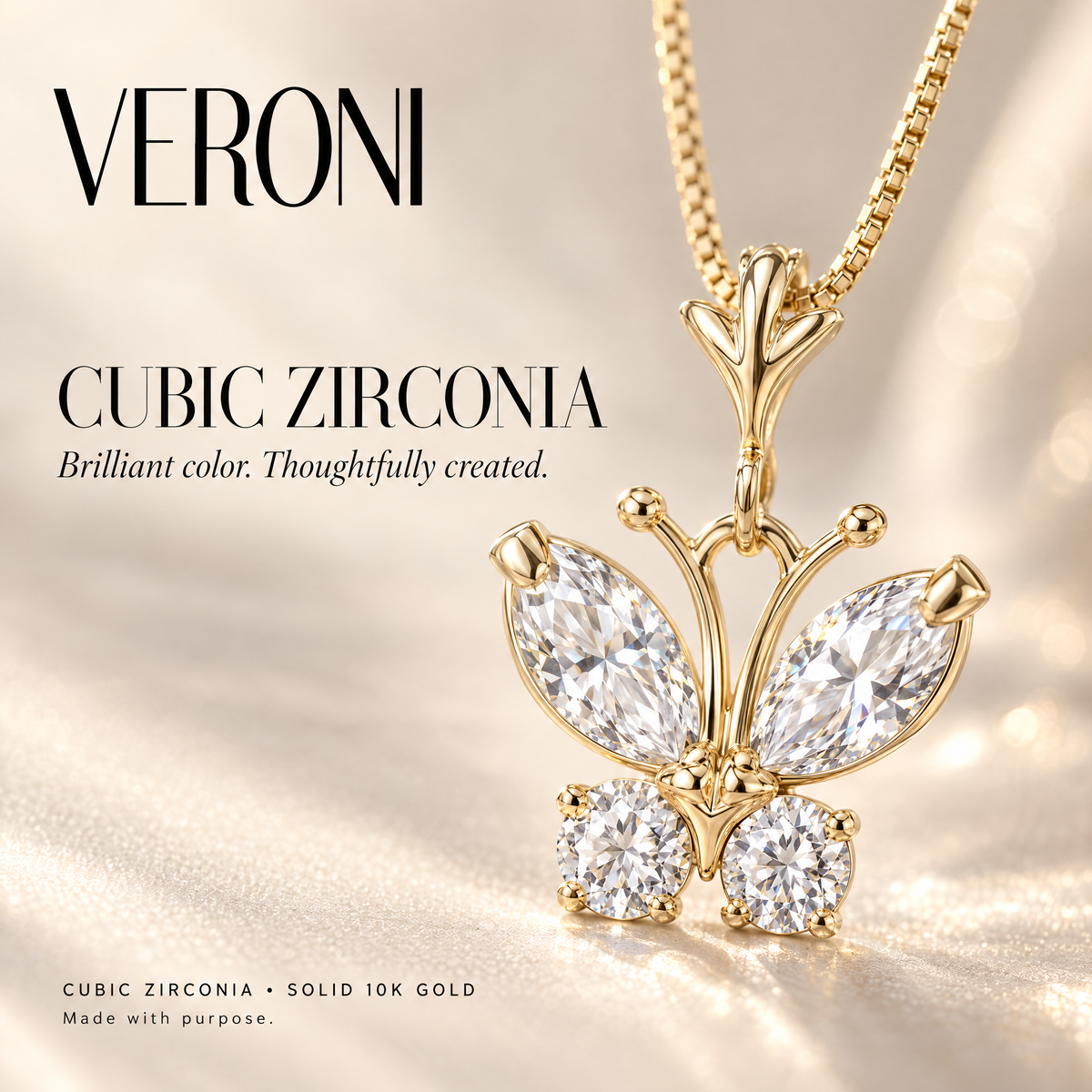 Yellow Gold Miranda cubic zirconia pendant on a warm ivory background in a VERONI campaign.