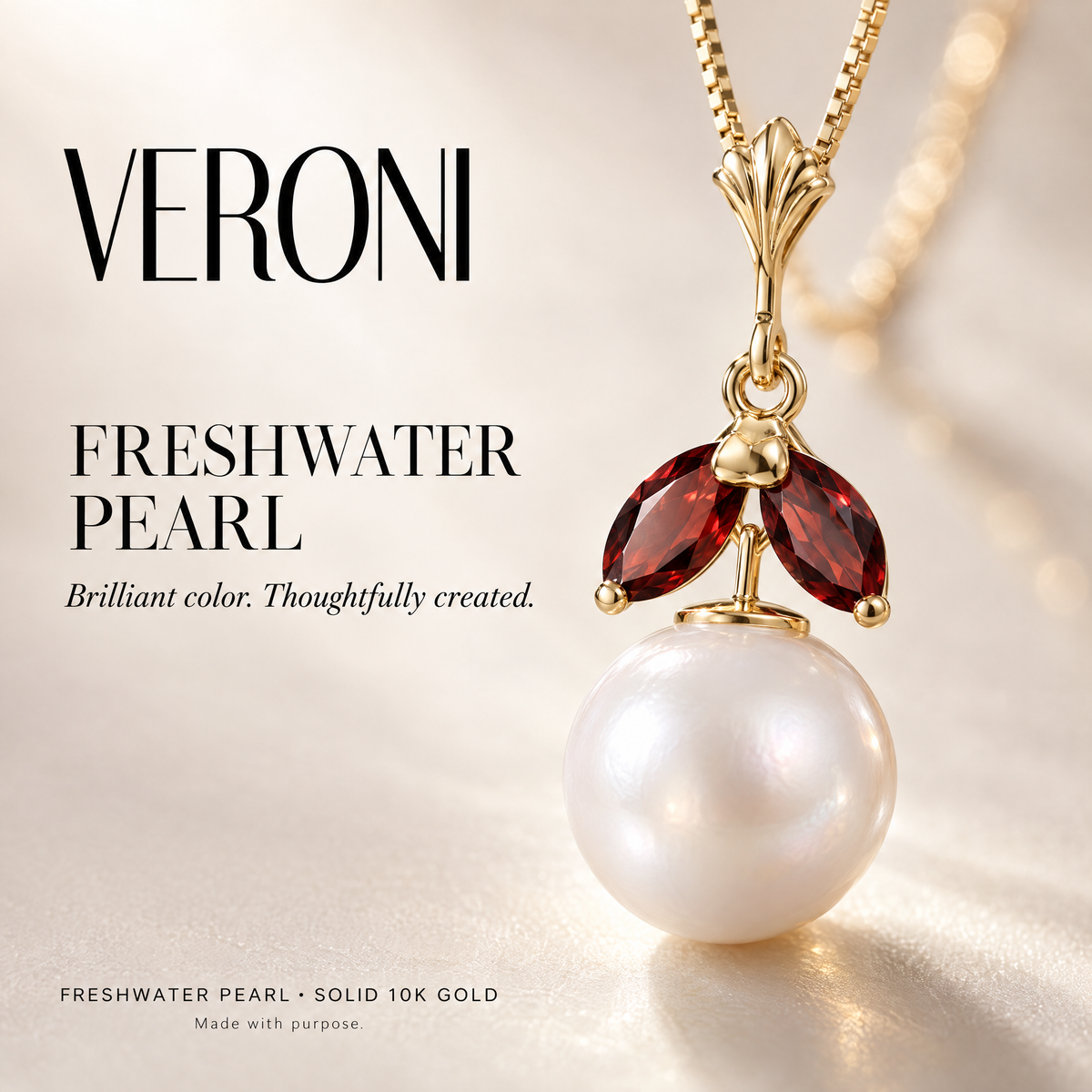 Yellow Gold Romilda freshwater pearl pendant on a warm ivory background in a VERONI campaign.