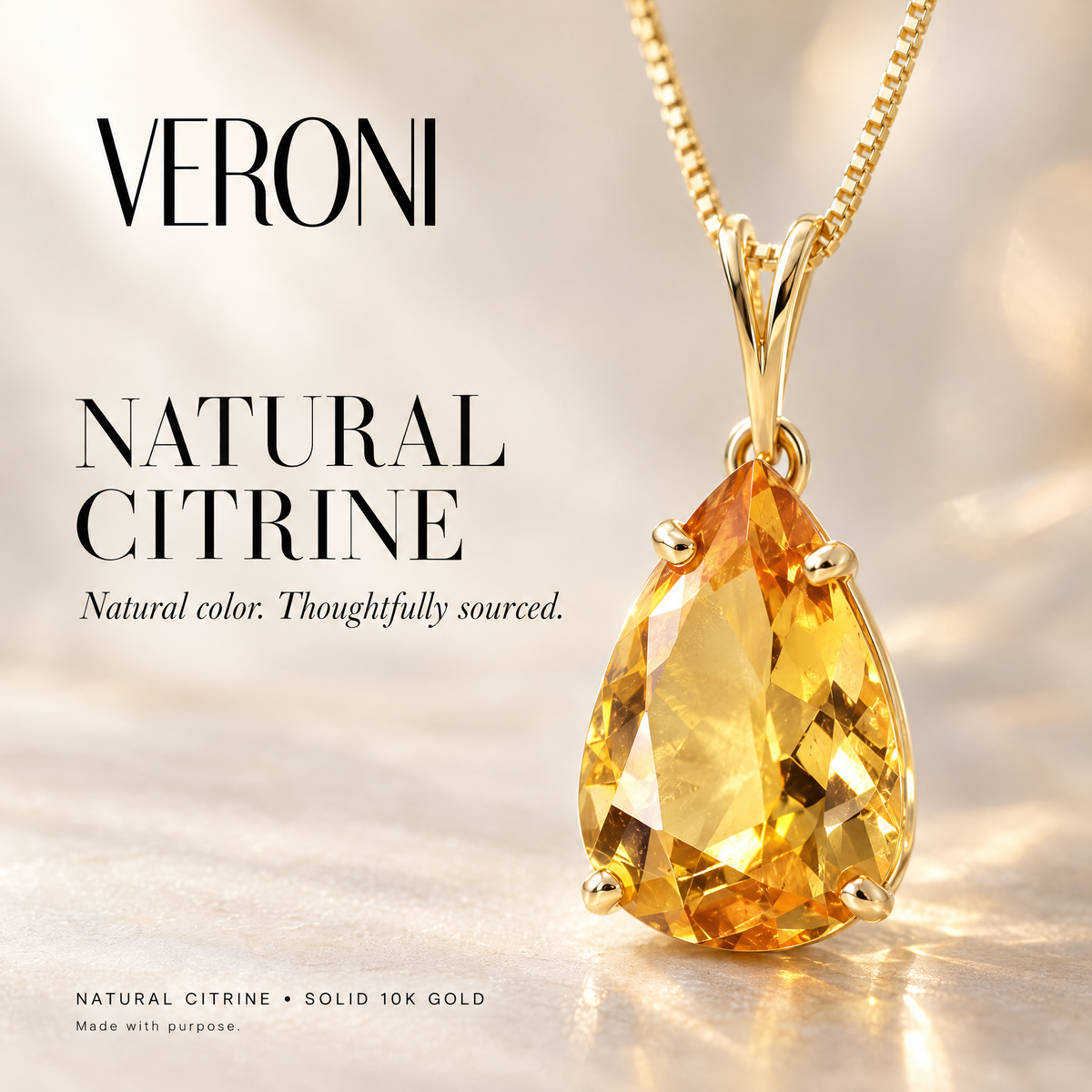 Yellow Gold Camelia natural citrine pendant on a warm ivory background in a VERONI campaign.