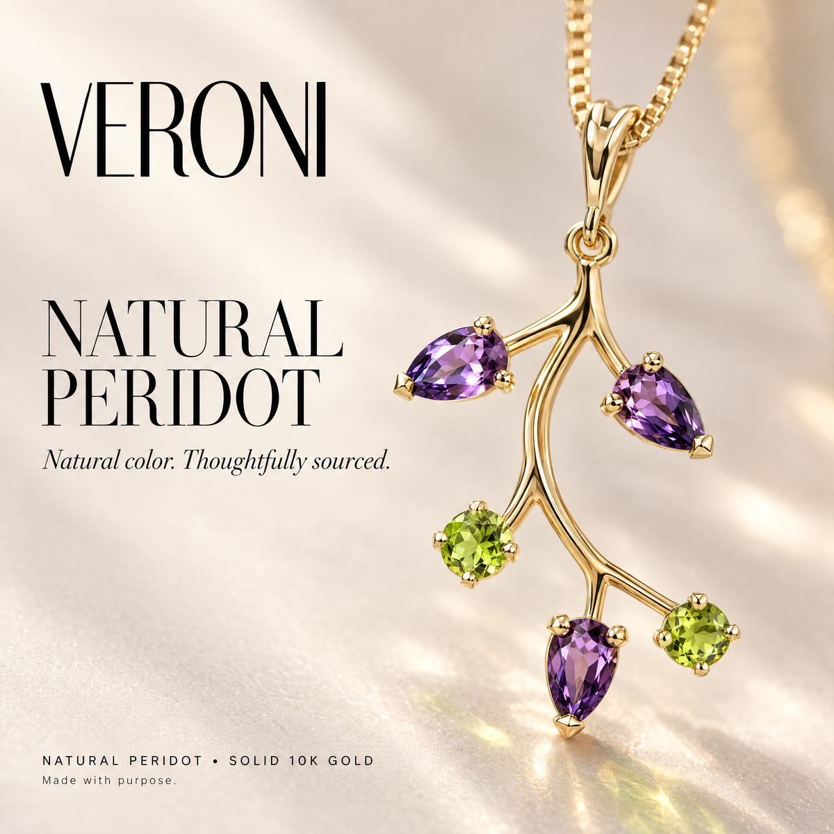 Yellow Gold Nadia natural peridot and amethyst pendant on a warm ivory background in a VERONI campaign.
