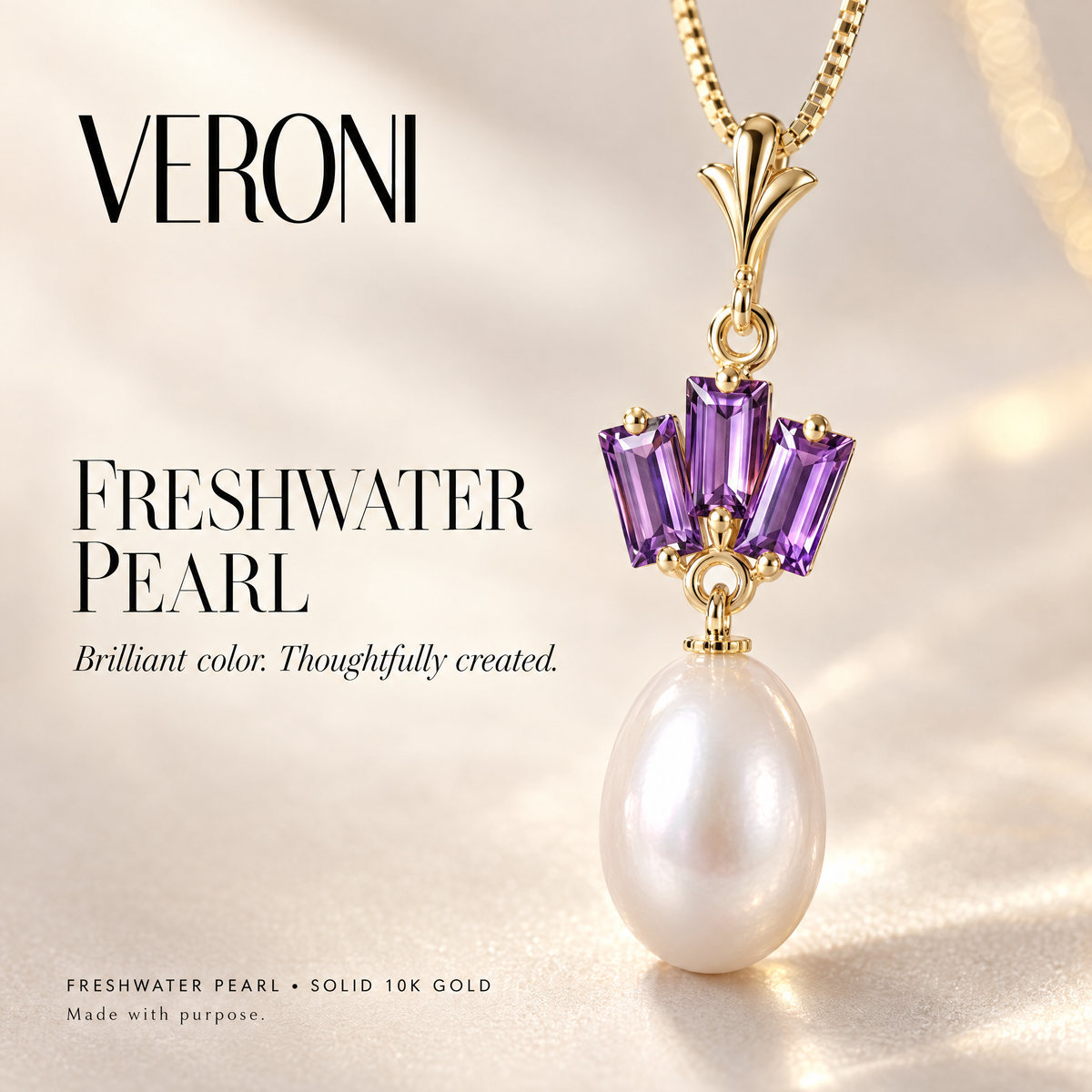 Yellow Gold Rossella freshwater pearl pendant on a warm ivory background in a VERONI campaign.