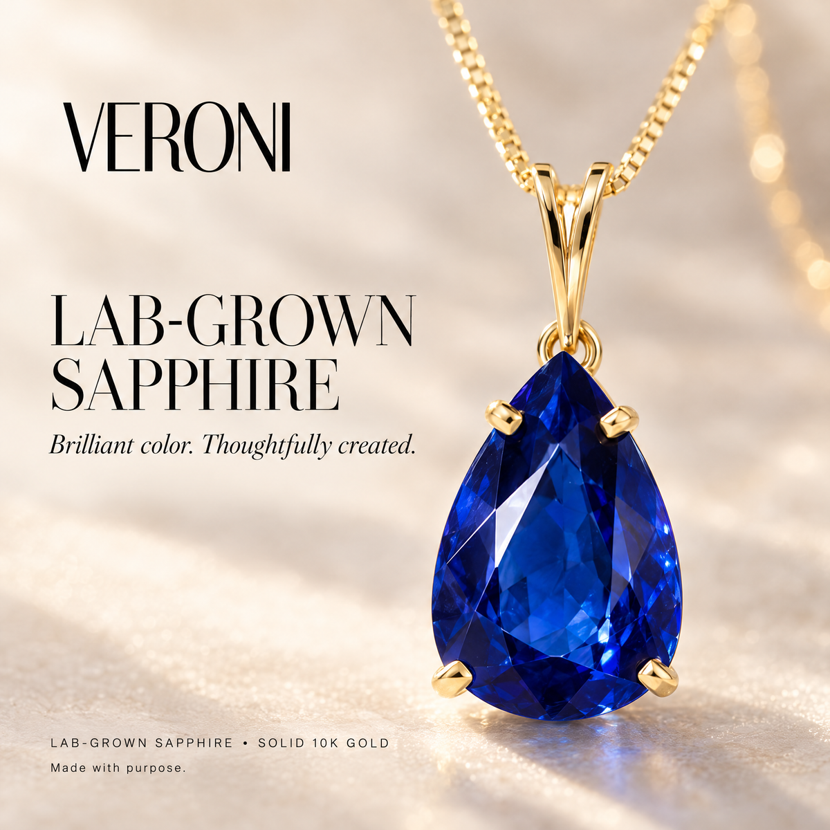Yellow Gold Bice lab-grown sapphire pendant on a warm ivory background in a VERONI campaign.