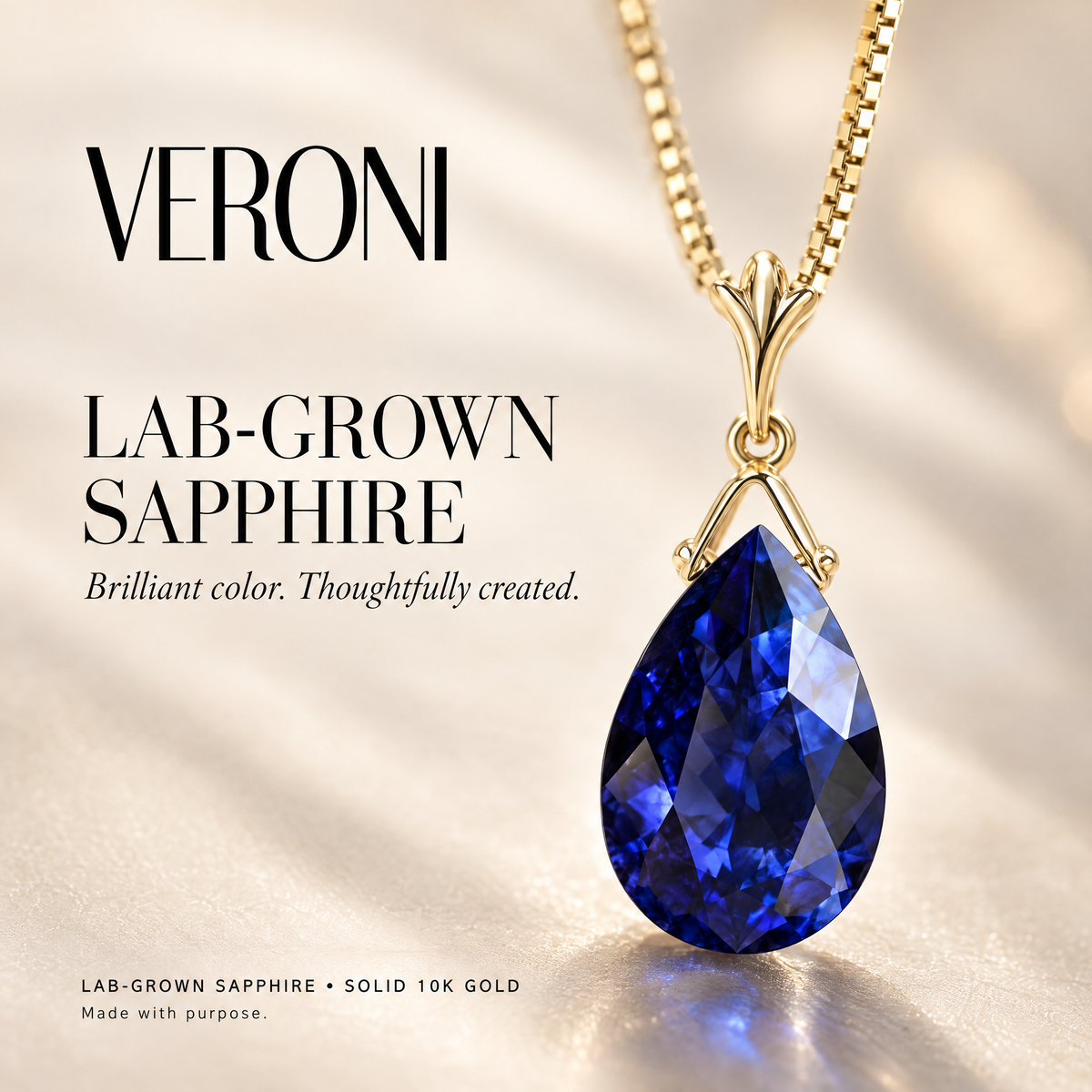 Yellow Gold Giovanna lab-grown sapphire pendant on a warm ivory background in a VERONI campaign.