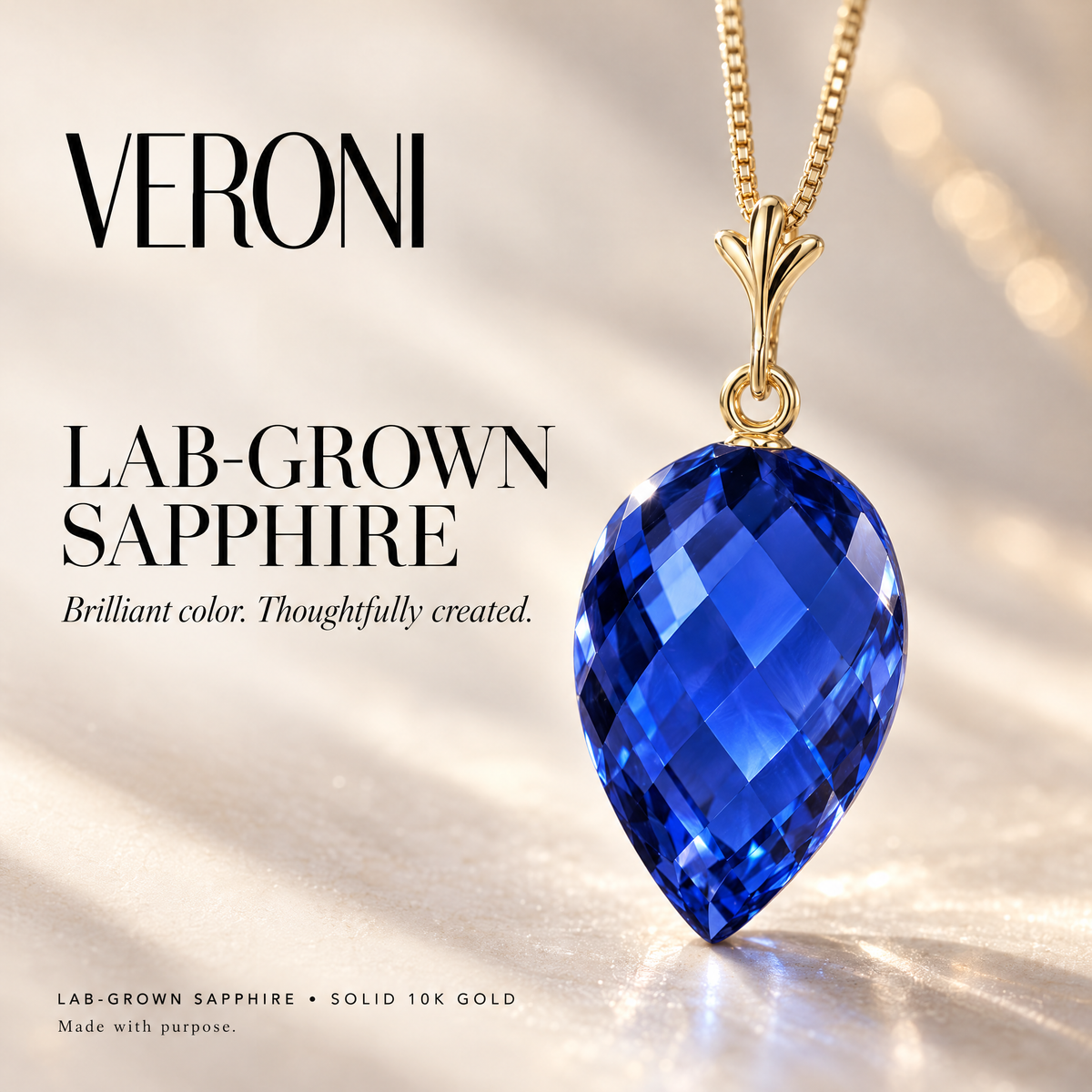 Yellow Gold Ornella lab-grown sapphire pendant on a warm ivory background in a VERONI campaign.