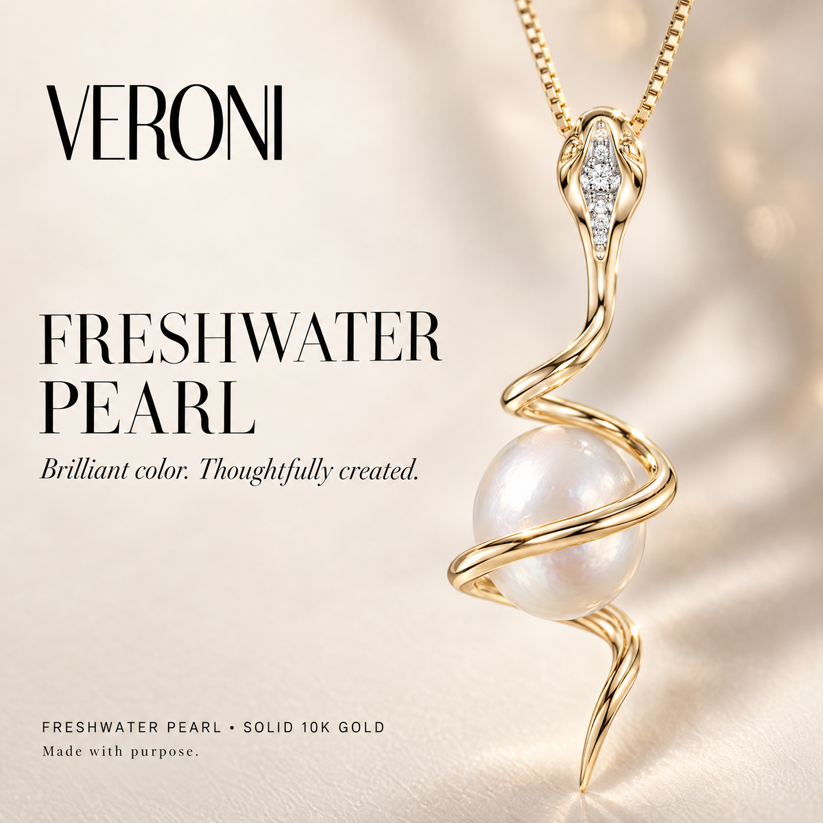 Yellow Gold Adele freshwater pearl pendant on a warm ivory background in a VERONI campaign.