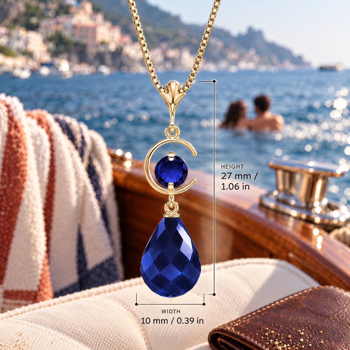 Yellow Gold Nicolina sapphire pendant with dimensions: 27 mm high and 10 mm wide, against a boat setting.